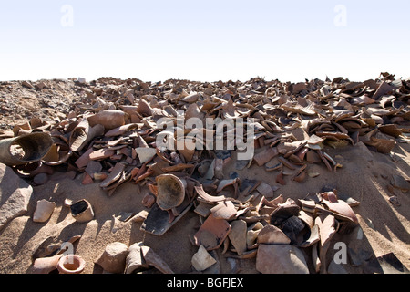 Piles of ancient pottery shards on the desert floor at Daydamus Roman Fort in the Eastern Desert of Egypt , North Africa