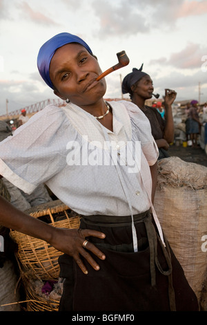 A woman smoking a pipe at the port in Gonaives, Artibonite Department, Haiti. Stock Photo