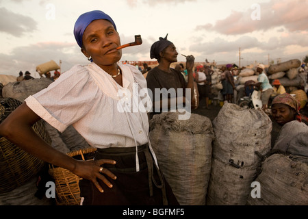 A woman smoking a pipe at the port in Gonaives, Artibonite Department, Haiti. Stock Photo