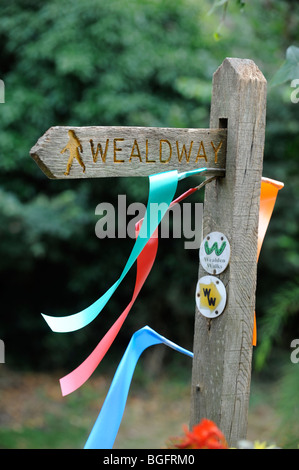 A  decorated footpath sigh for the Wealdway in in the village of Arlington near Lewes, East Sussex. Stock Photo