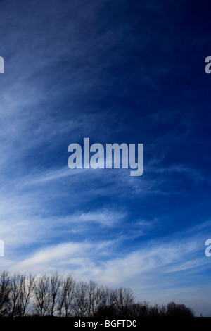 White Whispy High Cirrus Fibratus clouds in deep blue sky Stock Photo