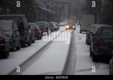 Single car struggles through snow. Clapham/Battersea, London, UK. Stock Photo