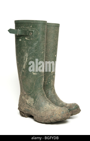 Pair of muddy green wellington boots isolated on white Stock Photo