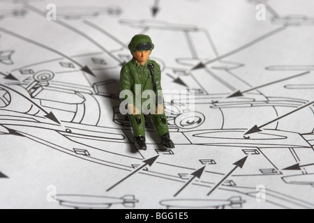 toy plane roughly painted pilot sitting on construction kit with instructions Stock Photo