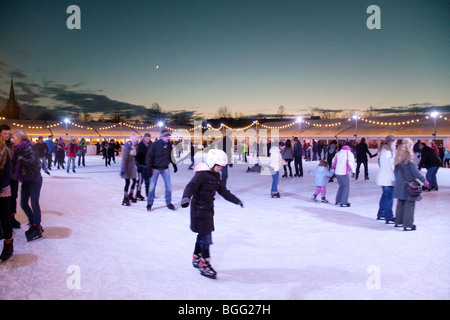 Ice skaters on the outdoor ice rink at Christmas, Parkers Piece, Cambridge UK Stock Photo
