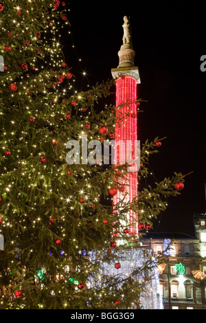 Statue of Sir Walter Scott seen through christmas tree lights in George Square Glasgow Stock Photo