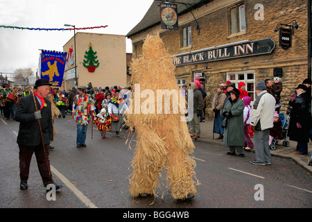 Parading the Straw Bear Festival through Whittlesey Town Fenland Cambridgeshire England UK Stock Photo