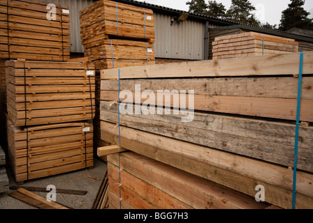 Modern treated wooden fencing in stacks at timber Merchants, England Stock Photo