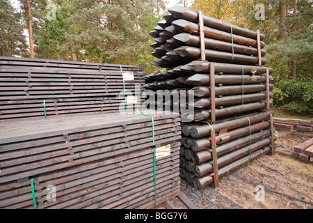 Modern treated wooden fencing in stacks at timber Merchants, England Stock Photo