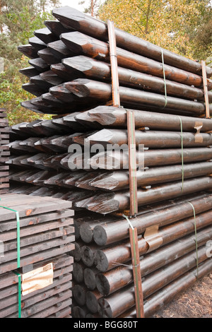 Modern treated wooden fencing in stacks at timber Merchants, England Stock Photo