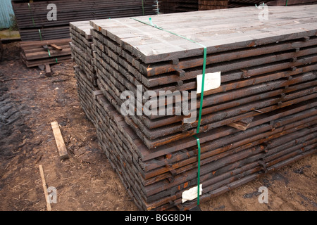 Modern treated wooden fencing in stacks at timber Merchants, England Stock Photo