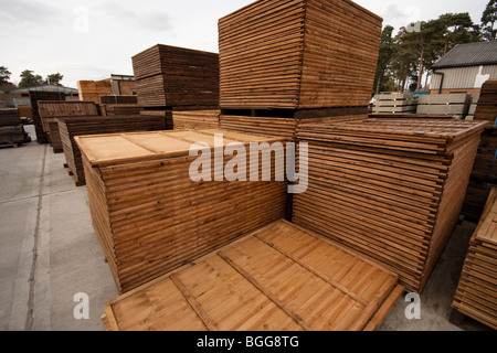 Modern treated wooden fencing in stacks at timber Merchants, England Stock Photo