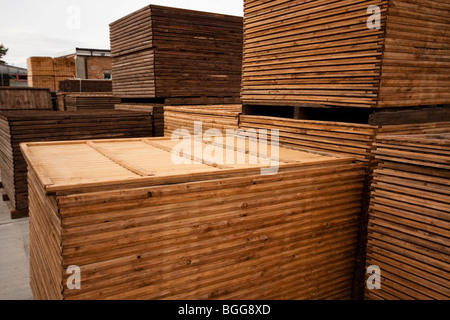 Modern treated wooden fencing in stacks at timber Merchants, England Stock Photo