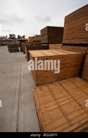 Modern treated wooden fencing in stacks at timber Merchants, England Stock Photo