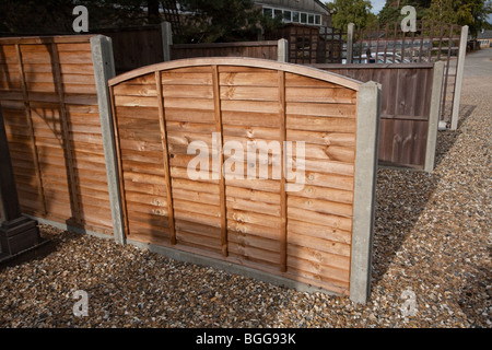 Modern treated wooden fencing with concrete posts at Timber Merchants, England Stock Photo