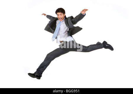Young businessman jumping in mid-air Stock Photo