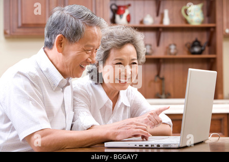 Senior couple using laptop Stock Photo