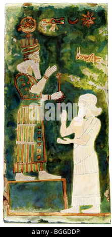 Sargon (left) pays homage to the Assyrian god Asur.  This wall painting decorated brick tile in a house in Assur. Stock Photo