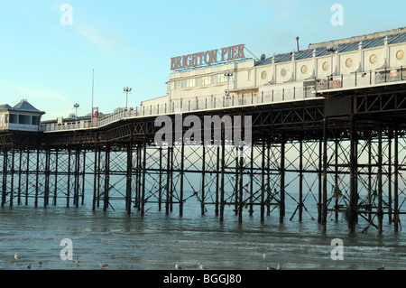 Early morning winter sun lights up Brighton Pier on the South coast of England. Stock Photo