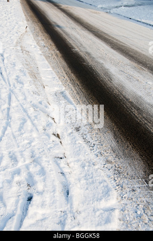 Tyre tracks on ice and snow on a highway Stock Photo - Alamy