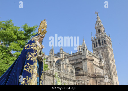 Procession with cathedral and Giralda tower in the back, Sevilla, Andalucia, Spain Stock Photo