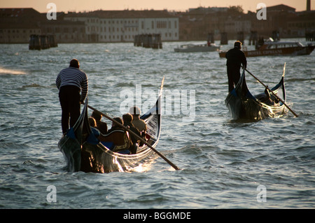 Two fully occupied gondolas on broad canal, Venice, Italy, rear view Stock Photo