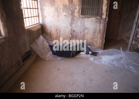 Homeless man sleeping in an abandoned building Stock Photo