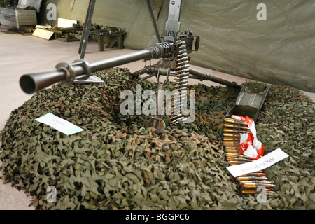 Portuguese Army Browning M2HB heavy machine gun, mounted on a tripod, and some ammunitions. Stock Photo