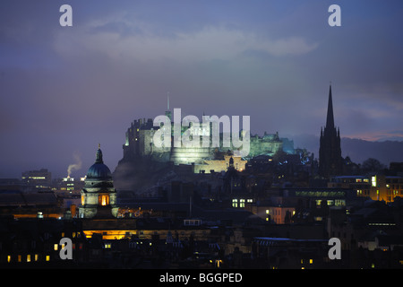 Edinburgh Castle, Scotland, at dusk in winter. On the left is the dome of the Talbot Rice Gallery, on the right the Hub. Stock Photo