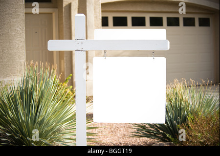 A home for sale has a for sale sign that is blank for copy space. Stock Photo