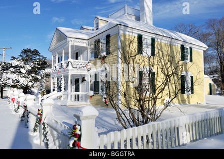 Historic House icovered with fresh snow decorated for Christmas in Falmouth, Cape Cod USA. Stock Photo