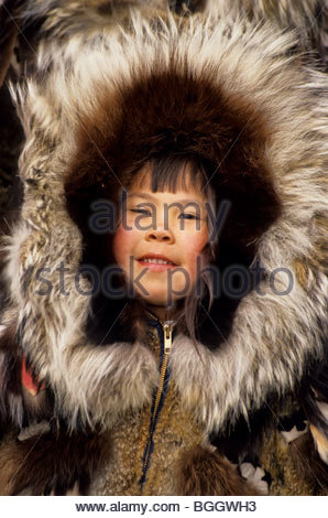 An Alaskan Inupiat Eskimo girl wearing a caribou skin parka with Stock ...