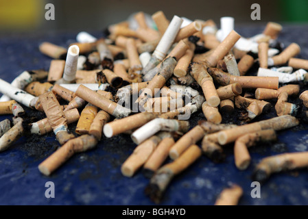 cigarette butts over flow on top of a bin. Stock Photo