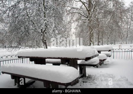 Table and benches in St James Park in Central London covered in deep snow Stock Photo
