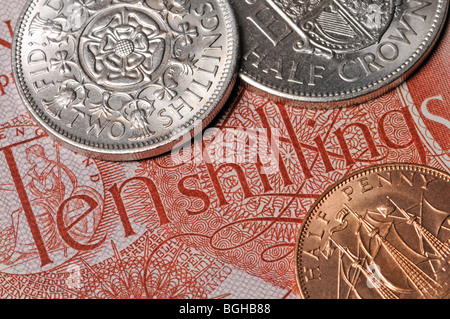 Pre-decimal British currency - half Crown, Florin and Half Penny on a ten shilling note Stock Photo