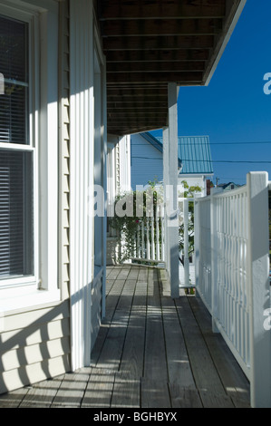Railing shadows on wooden front porch Stock Photo
