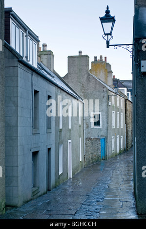 he narrow paved and cobbled main street in Stromness Mainland Orkney, Highland Region Scotland. SCO 5816