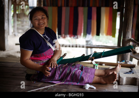 A woman from the Karen hill tribe in northern Thailand weaves textiles Stock Photo