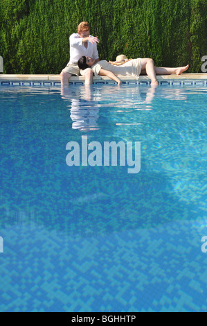 Young couple by the swimming pool Stock Photo