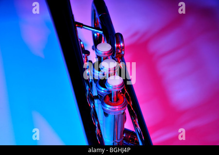 Trumpet under coloured lighting showing close up of the valves. Stock Photo