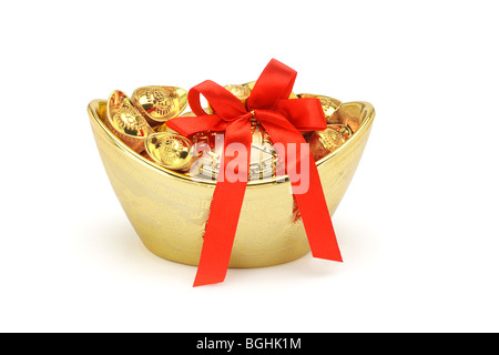 Chinese New Year gold decorative ingots with red bow ribbon on white background Stock Photo
