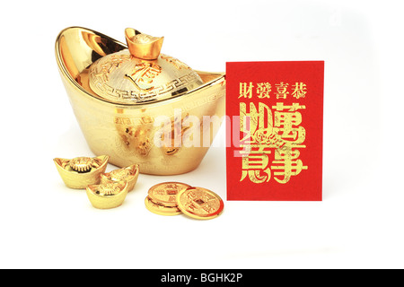 Chinese new year gold ingots and red packet on white background Stock Photo