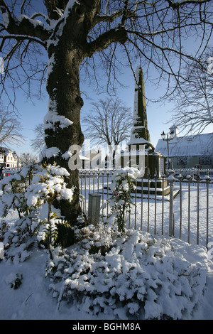 Village of Holt, Wales. Picturesque view of the First and Second World War memorial in Holt village centre on a cold, snowy day. Stock Photo