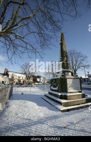 Village of Holt, Wales. Picturesque view of the First and Second World War memorial in Holt village centre on a cold snowy day. Stock Photo