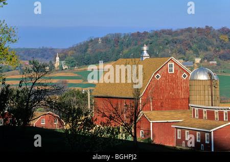 Red Barn With village of St. Donatus in background, October, Jackson County, Iowa, USA Stock Photo