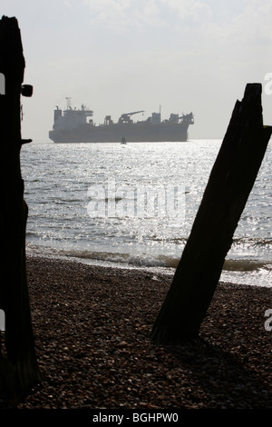 Cargo Container Ship Stumps of old piers Stock Photo - Alamy