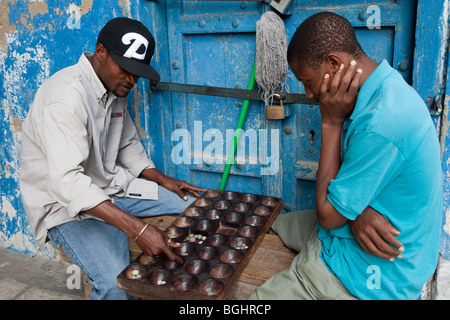 Zanzibar, Tanzania. Men Playing Bao, a Traditional African Game. Stock Photo