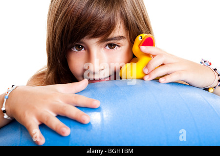 Happy little child smiling and playing with a yellow rubber duck Stock Photo
