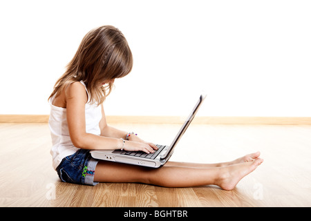 Little child learning how to use a laptop Stock Photo