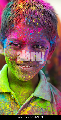 Young Indian boy covered in coloured powder pigment